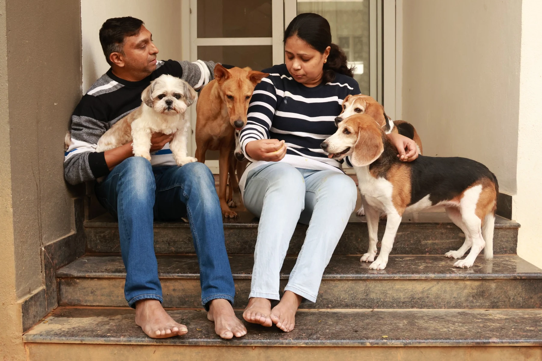 Pet-parent couple with their furkids at home